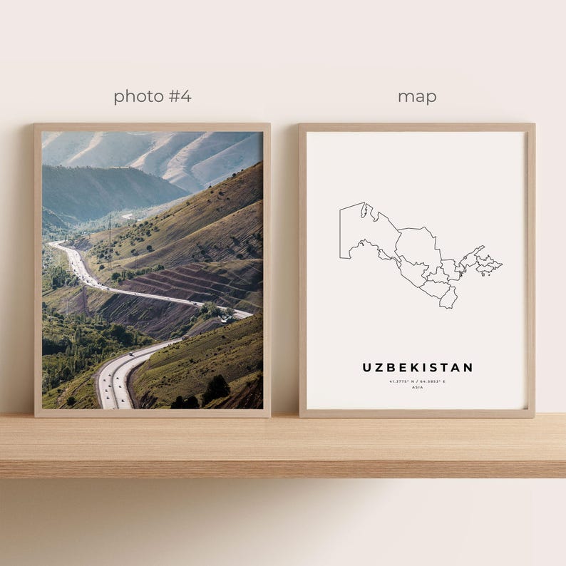 May include: Two framed prints on a wooden shelf. One print is a photograph of a winding road through a mountain range. The other print is a minimalist map of Uzbekistan with the country's name and coordinates.