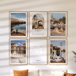 May include: Six framed art prints featuring scenes from Libya. The prints include landscapes, architecture, and a map of Libya. Each print is in a wooden frame, creating a cohesive gallery wall display. The word "LIBYA" is printed on some of the prints.