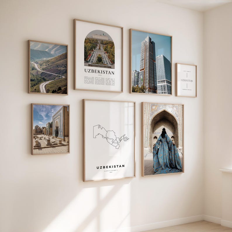 May include: A collection of framed art prints featuring images of Uzbekistan. The prints include landscapes, architecture, and cityscapes, with the word "UZBEKISTAN" displayed on some. The frames are a light brown color, and the prints are hung on a white wall.