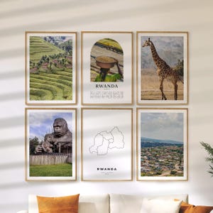 May include: Six framed wall art prints featuring images of Rwanda. The prints include a landscape of terraced hills, a person carrying a basket, a giraffe, a gorilla statue, a map outline, and a cityscape. The prints are in wooden frames.