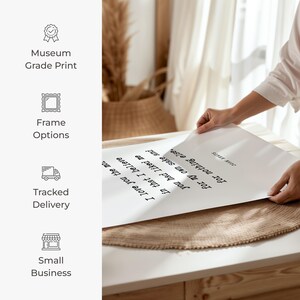 a person placing a piece of paper on top of a table