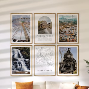 May include: Six framed wall art prints featuring scenic views of Pigeon Forge, Tennessee. The prints include a Ferris wheel, a water mill, a mountain town, a waterfall, a map, and a vintage steam train. Each print is in a wooden frame.