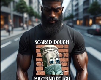 May include: A black t-shirt with a graphic of a cartoon dollar bill with googly eyes and a face mask. The text "Scared Dough Makes No Dough - Hustle Up -" is printed on the shirt.