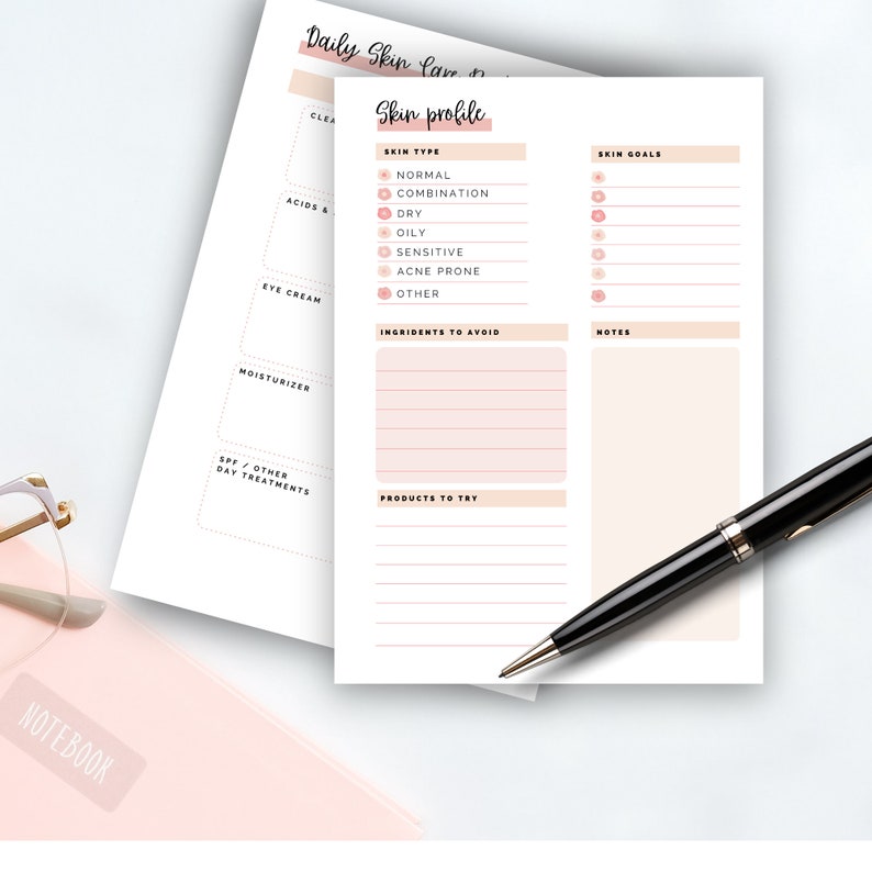 May include: A white and peach-colored skincare planner with sections for skin type, goals, and notes. The planner includes prompts for ingredients to avoid and products to try. A black pen rests on the page.