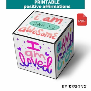 May include: Printable positive affirmations cube with colourful text on each side. The sides say "I am awesome", "I am loved", "I am enough", and "I am strong".