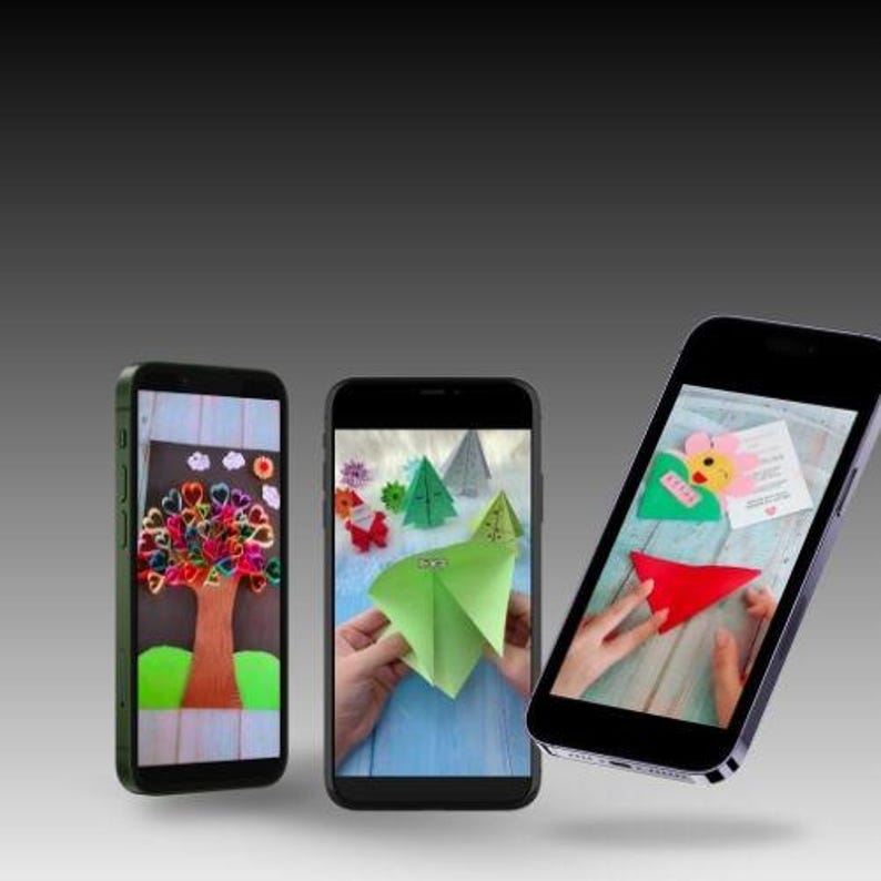 May include: Three smartphones showing craft projects. One displays a tree with a heart-shaped leaf design, another features origami trees and flowers, and the last displays a red paper shape.