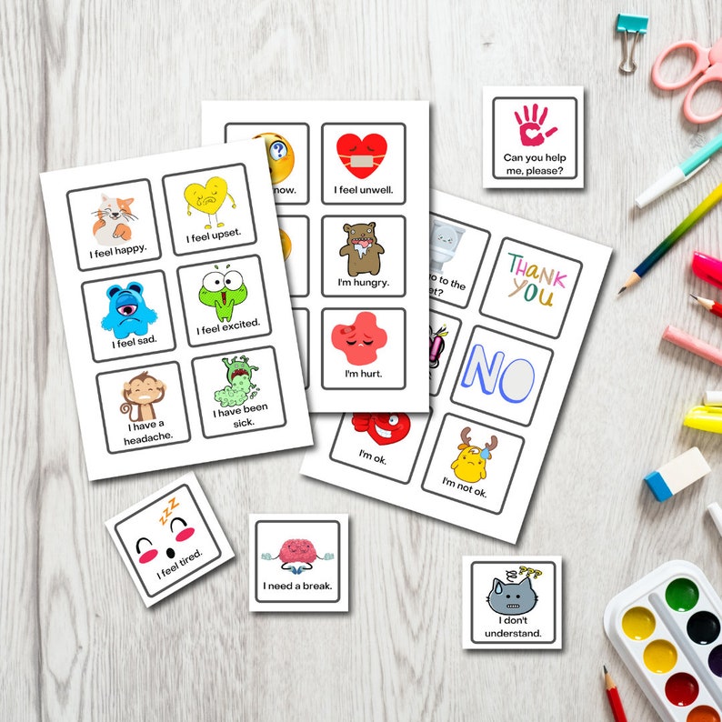 Puede incluir: Un conjunto de tarjetas de comunicaci&oacute;n coloridas con ilustraciones de dibujos animados y frases como "Me siento feliz", "Me siento triste", "Tengo hambre", "Necesito un descanso" y "No entiendo". Las tarjetas est&aacute;n dise&ntilde;adas para ayudar a las personas a comunicar sus necesidades y sentimientos.