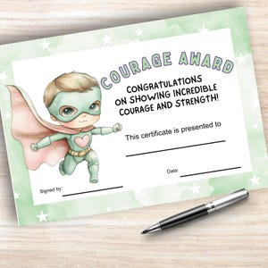 May include: A printable certificate with a green watercolor background and white stars. It features a cartoon superhero boy with a pink cape and a heart on his chest. The text reads "COURAGE AWARD" and "CONGRATULATIONS ON SHOWING INCREDIBLE COURAGE AND STRENGTH!"  This certificate is presented to [Name]  Signed by: [Name] Date: [Date]