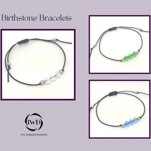 May include: Three adjustable black cord bracelets with silver beads and crystal birthstone charms. The charms are clear, green, and blue.