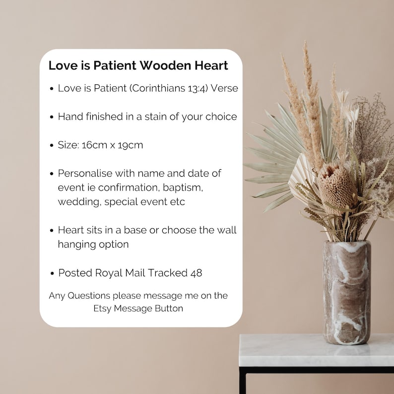 May include: A wooden heart with the text "Love is Patient" and the verse from Corinthians 13:4. The heart measures 6.3 inches by 7.5 inches and can be personalized for events like weddings or baptisms. It can sit in a base or be wall-mounted.