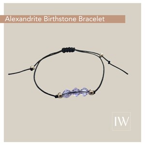 May include: A black adjustable string bracelet with a silver clasp and three light purple crystal beads. The bracelet is labeled "Alexandrite Birthstone Bracelet".