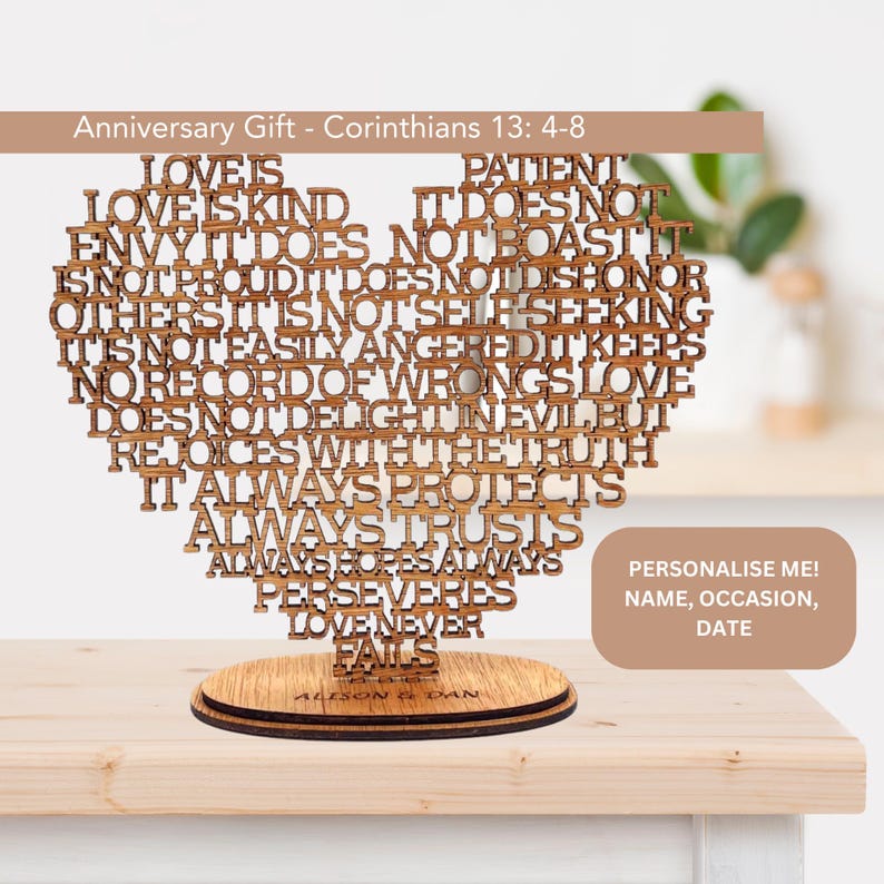 May include: Wooden heart-shaped sign with the text "Love is patient, love is kind..." from Corinthians 13:4-8. The sign is on a wooden base and can be personalized with a name, occasion, and date.