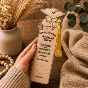 May include: A wooden bookmark with a graduation cap and tassel design. The bookmark has the text "CONGRATULATIONS BA (Hons) History UNIVERSITY OF PLYMOUTH CLASS OF 2024" and space for custom text. A yellow tassel hangs from the cap.