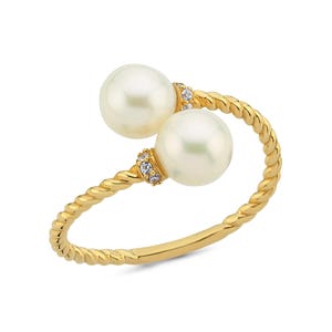 May include: A gold ring with a twisted band and two white pearls. The pearls are set on either side of the band and are accented with small diamonds.