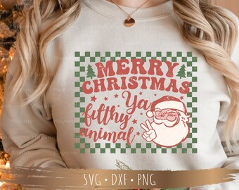 May include: A white sweatshirt with a green and white checkered background. The text "Merry Christmas Ya Filthy Animal" is written in red and white letters with a vintage distressed look. A cartoon image of Santa Claus with a beard and a wink is in the center of the design. The text "SVG.DXF.PNG" is written in black at the bottom of the design.
