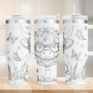 May include: A white stainless steel tumbler with a silver lid and a black and white line drawing of a highland cow wearing glasses and reading a book. The tumbler has a straw and a handle. The background is white with butterflies and flowers.