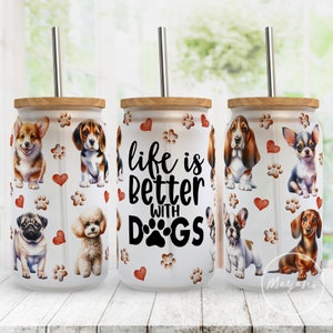May include: Three white stainless steel tumblers with a wood lid and a straw. Each tumbler features a different dog breed and paw prints. The middle tumbler has the text "life is better with DOGS" in black.