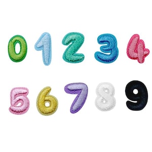 May include: A collection of embroidered number patches in a range of colours, including green, blue, pink, and yellow. The numbers 0 to 9 are shown, with the brand name "Longancraft" at the top. These patches are suitable for personalising clothing or accessories.