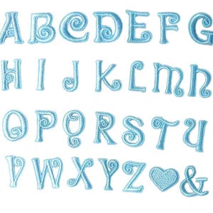 May include: Embroidered light blue alphabet letters, a heart, and an ampersand on a white background. The letters have a decorative swirl design. The brand name "Longancraft" is at the top of the image.