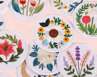 May include: Embroidered floral patches in various designs, including tulips, sunflowers, and lavender, on a white background. The patches feature detailed stitching in shades of red, yellow, blue, and green. The text "Longancraft" is displayed at the top.