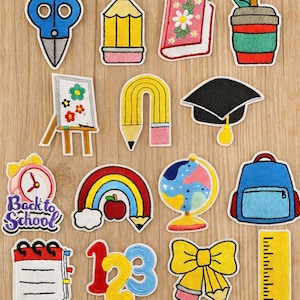 May include: A collection of colorful embroidered patches with school-themed designs. Includes scissors, pencils, books, a coffee cup, an easel, a graduation cap, a clock, a rainbow, a globe, a backpack, a calendar, numbers, a bow, and a ruler.