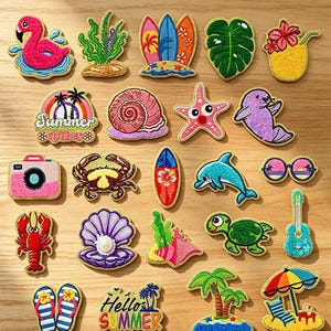 May include: A collection of twenty-four embroidered iron-on patches featuring summer and ocean themes, including a pink flamingo, surfboard, monstera leaf, pineapple, crab, dolphin, sea turtle, seashell, lobster, guitar, and flip-flops.