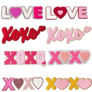 Può includere: Una collezione di toppe ricamate con le parole "LOVE" e "XOXO" in vari colori e stili. Le toppe presentano cuori e dettagli glitterati, perfette per aggiungere un tocco romantico a vestiti o accessori. Il marchio "Longancraft" è in alto.