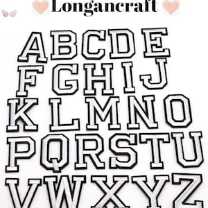 May include: A set of 26 white felt letters with black outlines, representing the English alphabet. The letters are arranged in alphabetical order, starting with A and ending with Z.
