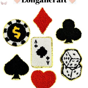 May include: Set of seven iron-on patches featuring various casino and gambling themed designs. The patches are made of fuzzy fabric and have gold outlines. The designs include a dollar sign inside a circle, a diamond, a club, a spade, an ace of spades, and two dice.