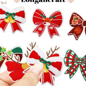 May include: Embroidered Christmas bow patches in red, white, and green. Some bows feature bells, snowflakes, or a reindeer design. The word "Longancraft" is at the top of the image.