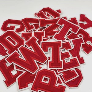 May include: A collection of red embroidered varsity letter patches with white borders. The letters are in a bold, block font. The brand name "Longancraft" is displayed at the top of the image.