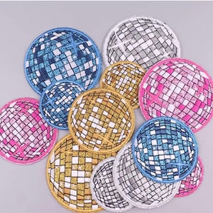 Può includere: Assortimento di otto toppe da stirare con design a palla da discoteca. Le toppe sono di vari colori, tra cui argento, oro, blu e rosa.