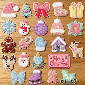 May include: A collection of twenty-three embroidered iron-on patches featuring Christmas themes including a Santa hat, tree, bows, stocking, gift, snowflake, snowman, ornament, beanie, poinsettia, gingerbread man, candy cane, mitten, house, reindeer, candle, and a sign reading Merry Christmas.