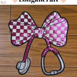 May include: Pink and white checkered bow with a silver stethoscope attached. The bow and stethoscope are made of sequins.
