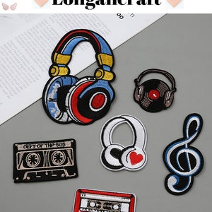 May include: Six embroidered iron-on patches featuring music-themed designs. The patches include a pair of headphones, a cassette tape, a treble clef, and a record player. The patches are on a gray background.