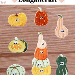 May include: A collection of embroidered pumpkin patches in shades of yellow, orange, green, and cream. The patches feature stitched details and cartoon eyes. The word "Longancraft" is displayed at the top of the image.