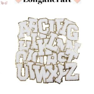 May include: A set of 26 white felt letters with gold glitter trim. The letters are in uppercase and are arranged in a random order. The letters are perfect for adding a personalized touch to crafts, clothing, and home decor.