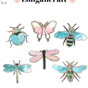 May include: Six colorful embroidered iron-on patches featuring a butterfly, two dragonflies, a bee, and two beetles. The patches are made of sequins and have a variety of colors, including pink, blue, green, and gold.