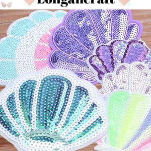 May include: A selection of sequined seashell patches in shades of blue, purple, and green. Each patch features a white border and is adorned with shimmering sequins. The text "Longancraft" is visible at the top of the image.