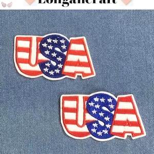 May include: Two embroidered "USA" patches in red, white, and blue. The "U" and "A" feature red and white stripes, while the "S" is blue with white stars. They are set against a blue denim backdrop. The brand name "Longancraft" is at the top.