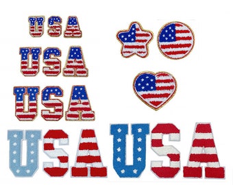 May include: A set of iron-on patches featuring the American flag in various shapes and sizes. The patches include a star, a heart, a circle, and the word "USA" in different styles. The patches are perfect for adding a patriotic touch to clothing, bags, or other accessories.