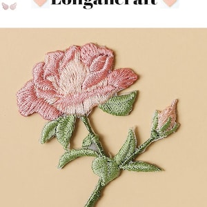 May include: Embroidered pink rose patch with green leaves and stem. The patch features the text "Longancraft" above the flower. The rose is in full bloom with detailed stitching, and the leaves and stem are a vibrant green.