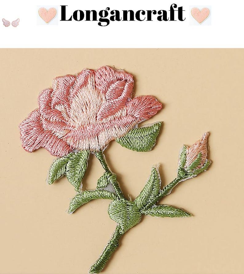 May include: Embroidered pink rose patch with green leaves and stem. The patch features the text "Longancraft" above the flower. The rose is in full bloom with detailed stitching, and the leaves and stem are a vibrant green.