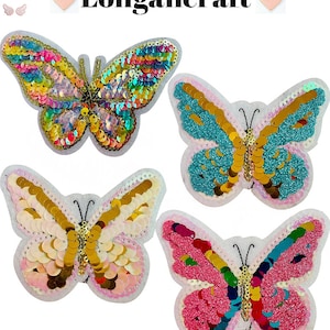 May include: Four colorful butterfly iron-on patches with sequins. The butterflies are pink, blue, gold, and rainbow.