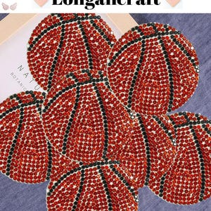 May include: Five red and black basketball-shaped patches covered in rhinestones. The patches are arranged in a cluster.