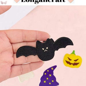 May include: A collection of Halloween-themed embroidered patches, including a black bat, a yellow jack-o'-lantern, a purple witch hat with yellow stars, and a white ghost. The brand name "Longancraft" is displayed at the top.