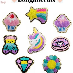 May include: A set of nine colorful felt iron-on patches featuring a variety of cute designs, including a unicorn, a donut, a cupcake, a star, a bear, a flower, and a diamond. The patches are perfect for adding a touch of whimsy to clothing, bags, or other accessories.