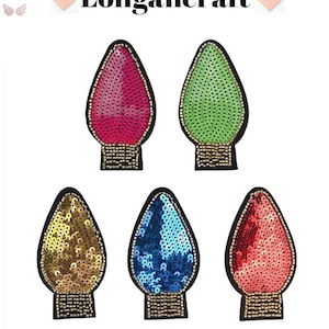 May include: Five Christmas light bulb shaped iron-on patches with sequins. The patches are in red, green, gold, blue, and pink.