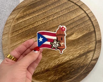 May include: A sticker featuring a red, white, and blue Puerto Rican flag with a red flower, a brown building, and a yellow and black symbol.