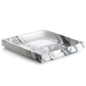 May include: A square tray featuring a white base with prominent black and grey marble veining patterns. The tray has a shallow, recessed centre and thick, angled outer edges, showcasing a polished stone-like appearance throughout the surface.